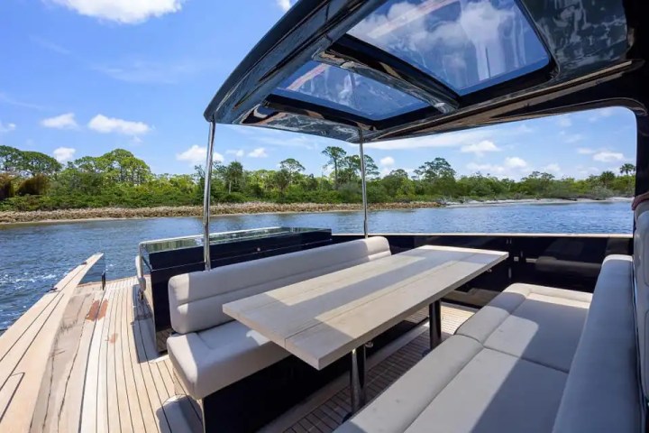Aft dining table of 45′ Alen boat set on teak deck