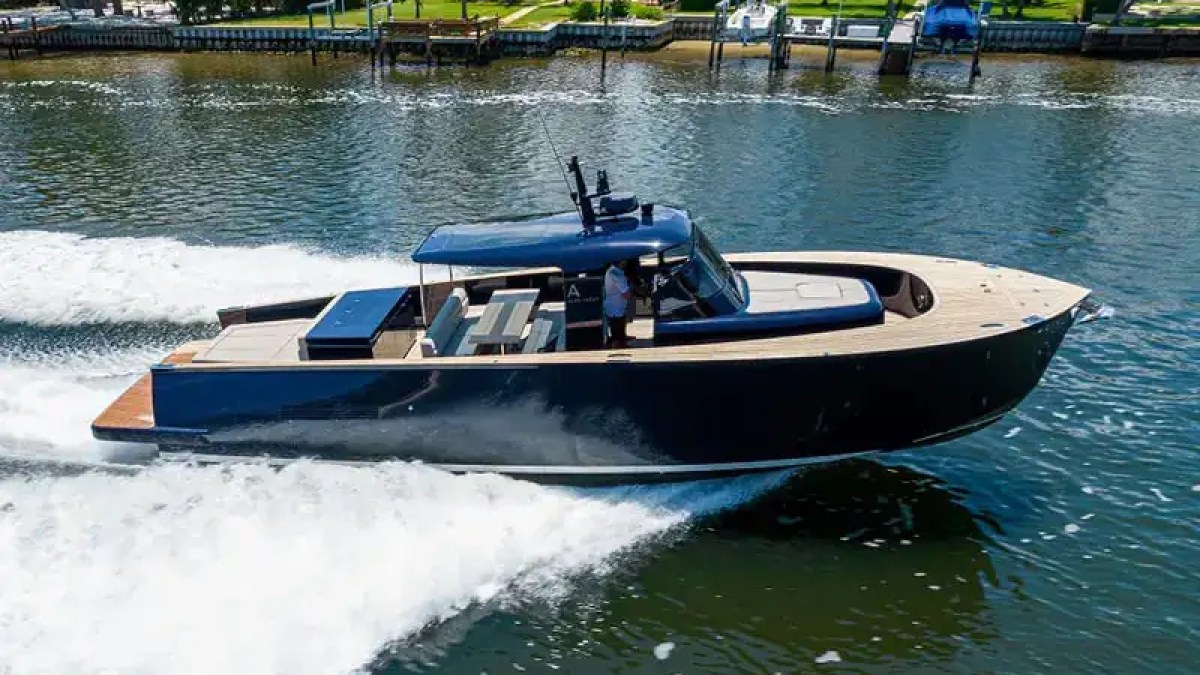 Captain driving 45′ Alen boat from modern helm