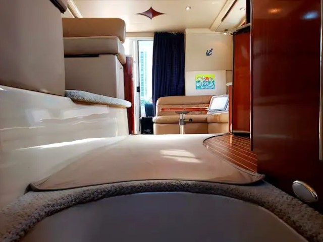 45 Meridian Boat Rental interior salon featuring plush seating, glossy wood cabinetry, natural lighting, and comfortable accommodations for luxury cruising in Miami.