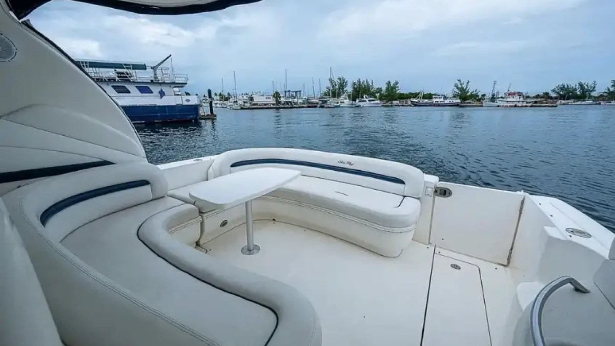 View from a boat's seating area overlooking a harbor and other boats.