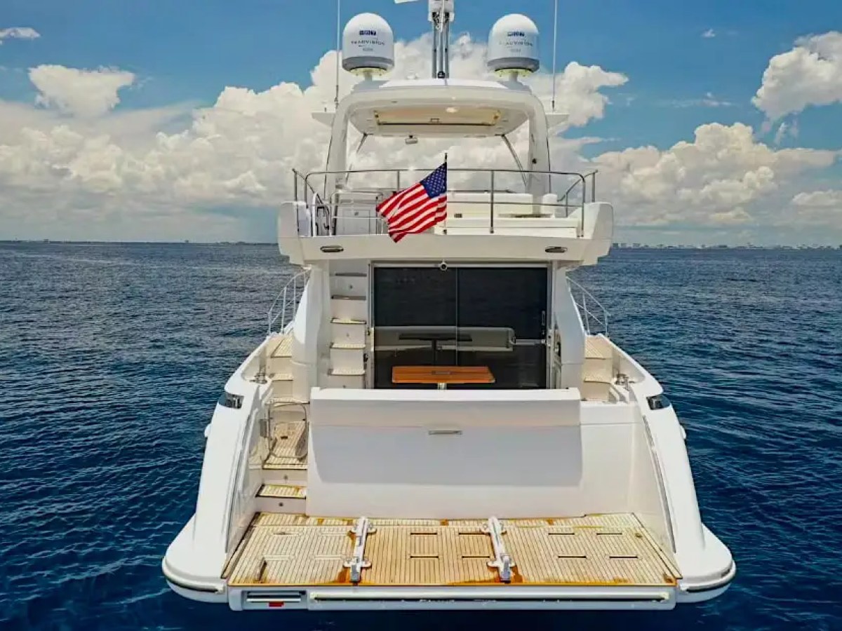 50 Azimut Yacht Charter stern view showcasing hydraulic swim platform, teak decking, flybridge access, and open-water cruising near Government Cut and Miami's Atlantic coastline