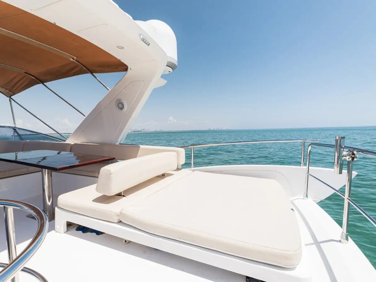 50 Azimut Yacht Charter flybridge sun pad with panoramic ocean views, plush lounge cushions, and luxury relaxation space cruising offshore near Key Biscayne and Stiltsville