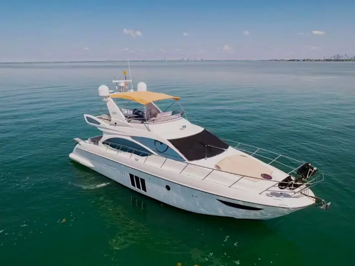 50 Azimut Yacht Charter captured from an aerial perspective showcasing sleek Italian lines, flybridge amenities, and crystal-clear waters near Cape Florida and the Miami coastline