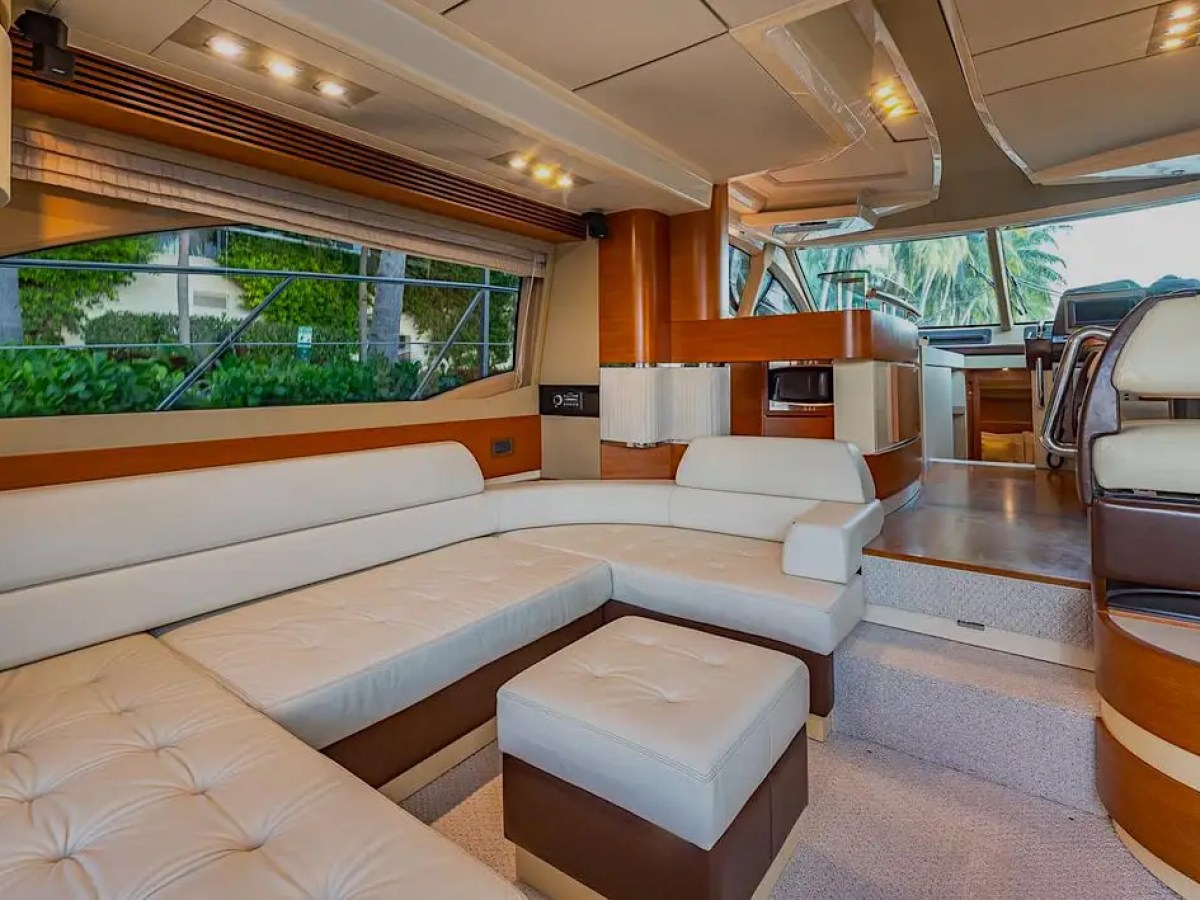 50 Azimut Yacht Charter salon featuring wraparound leather seating, premium wood finishes, and panoramic windows near Coconut Grove and Dinner Key in Miami