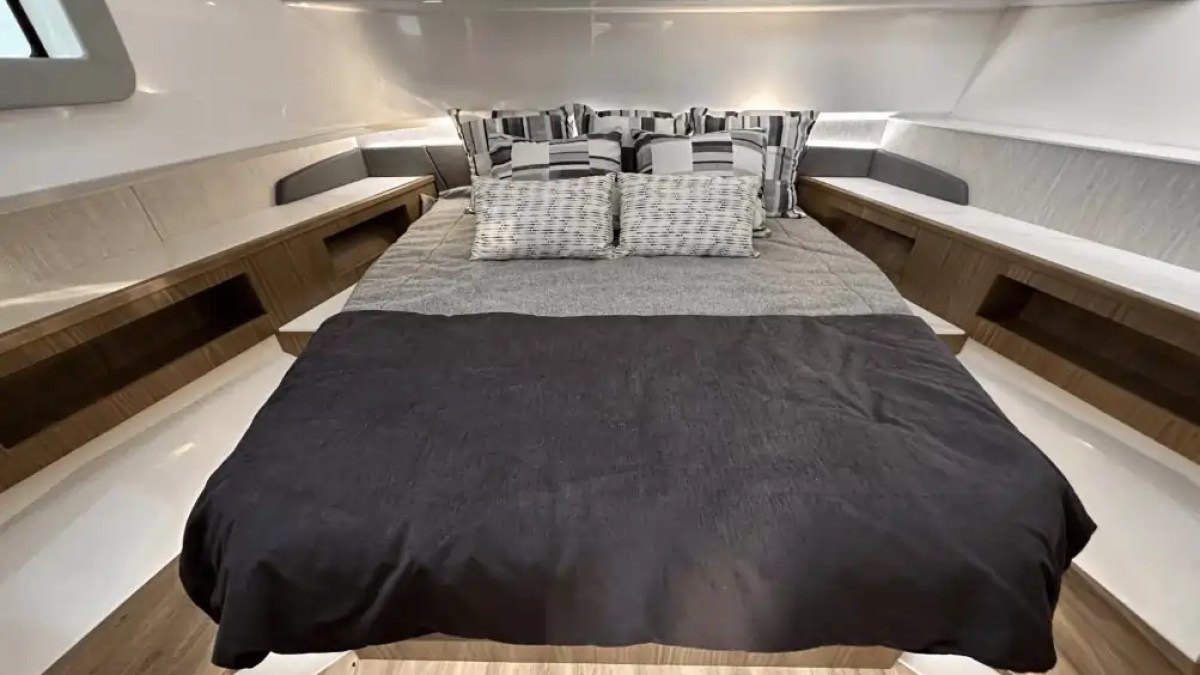 Interior view of a cozy bedroom with a neatly made bed and modern decor.