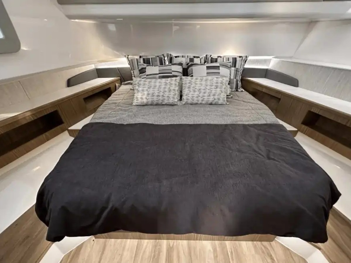 Interior view of a cozy bedroom with a neatly made bed and modern decor.