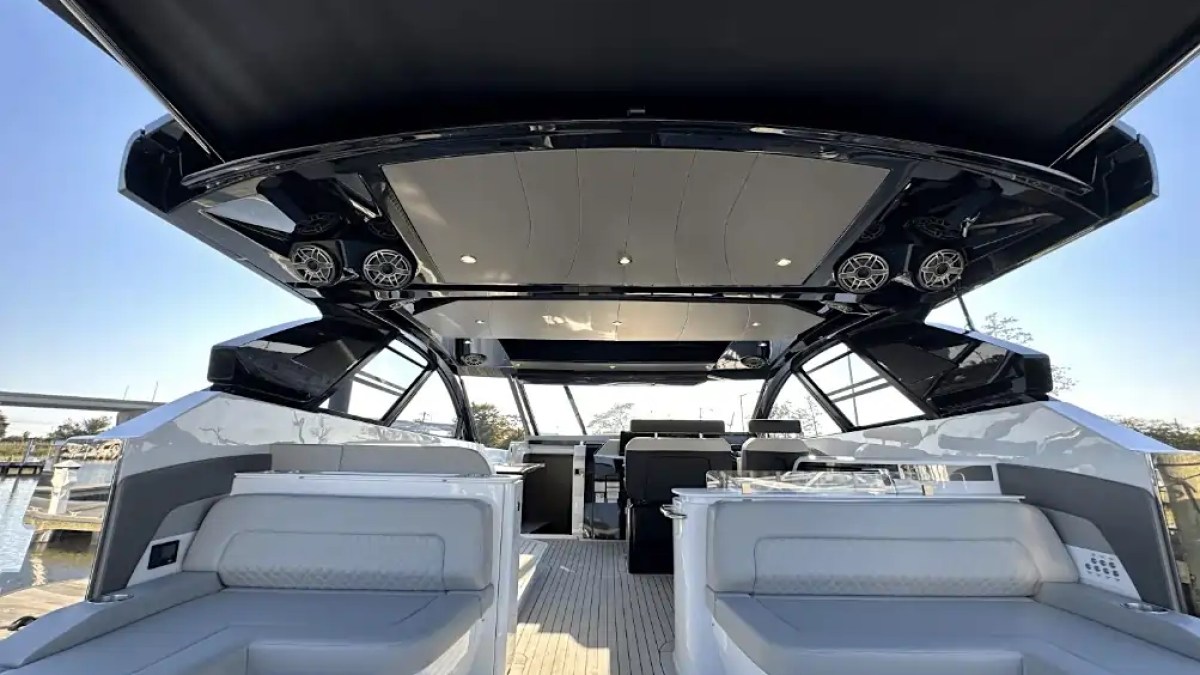 Interior view of a luxury yacht with seating and open roof.