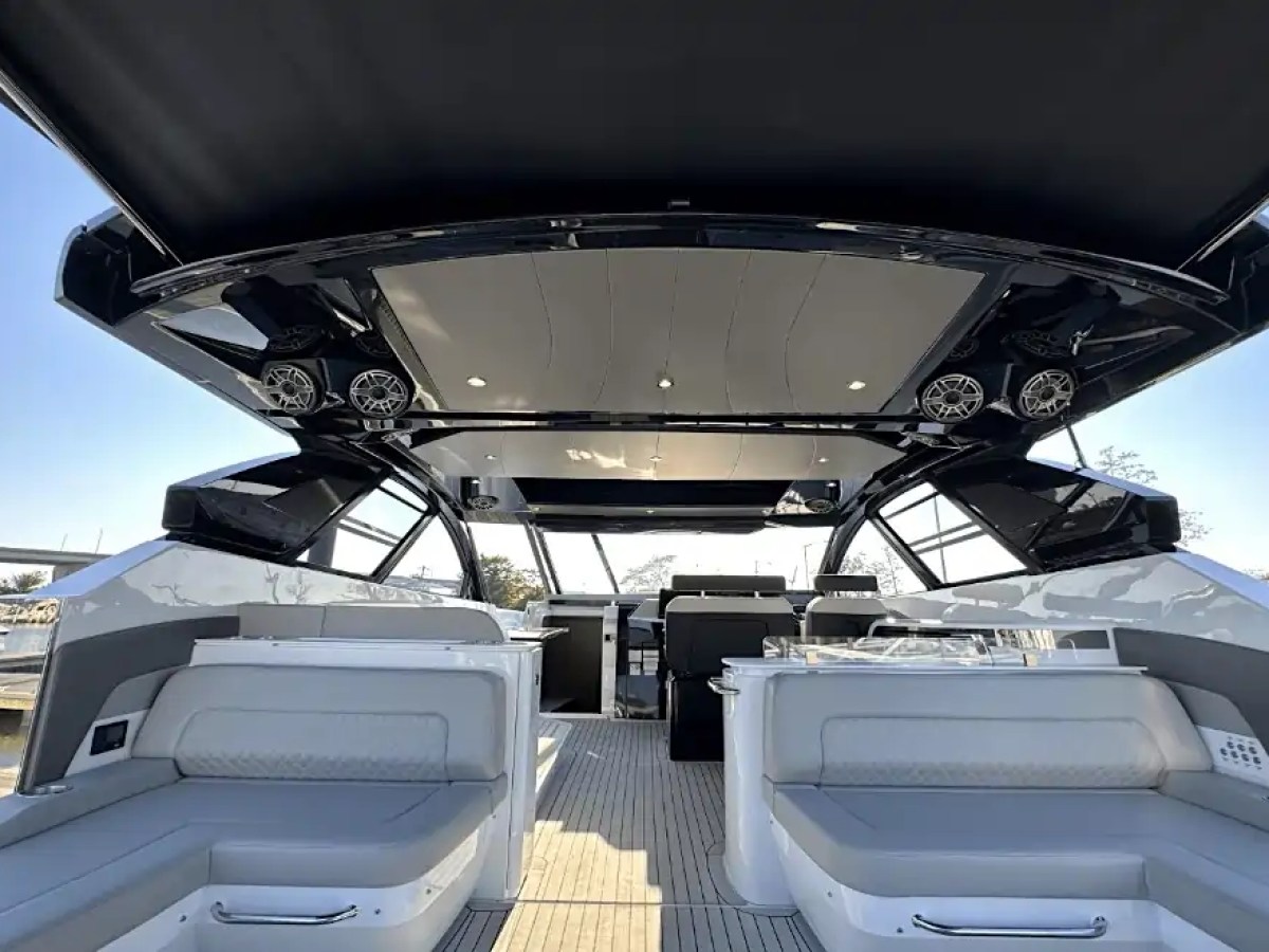 Interior view of a luxury yacht with seating and open roof.