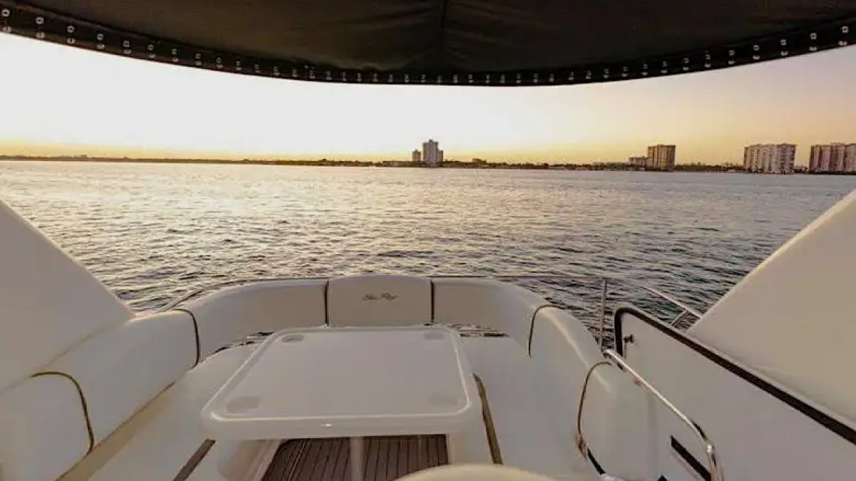 50' SeaRay yacht flybridge lounge area at sunset in Miami Beach