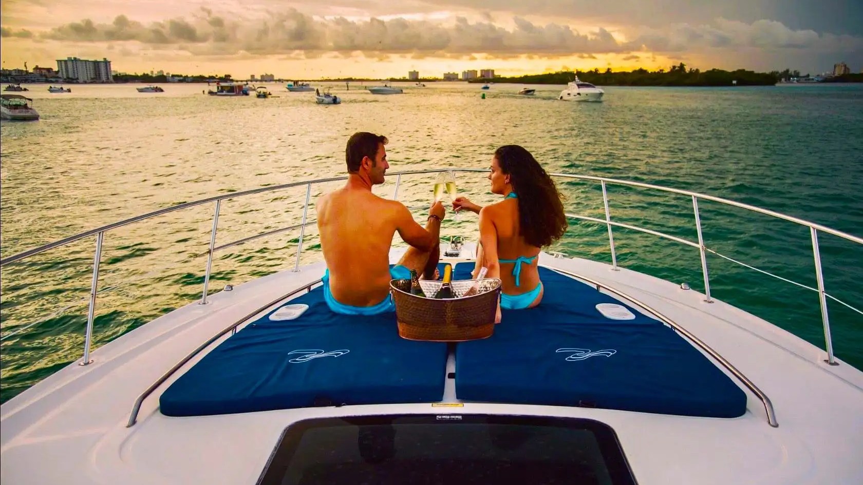 51' SeaRay yacht guests relaxing and celebrating on bow sunpad