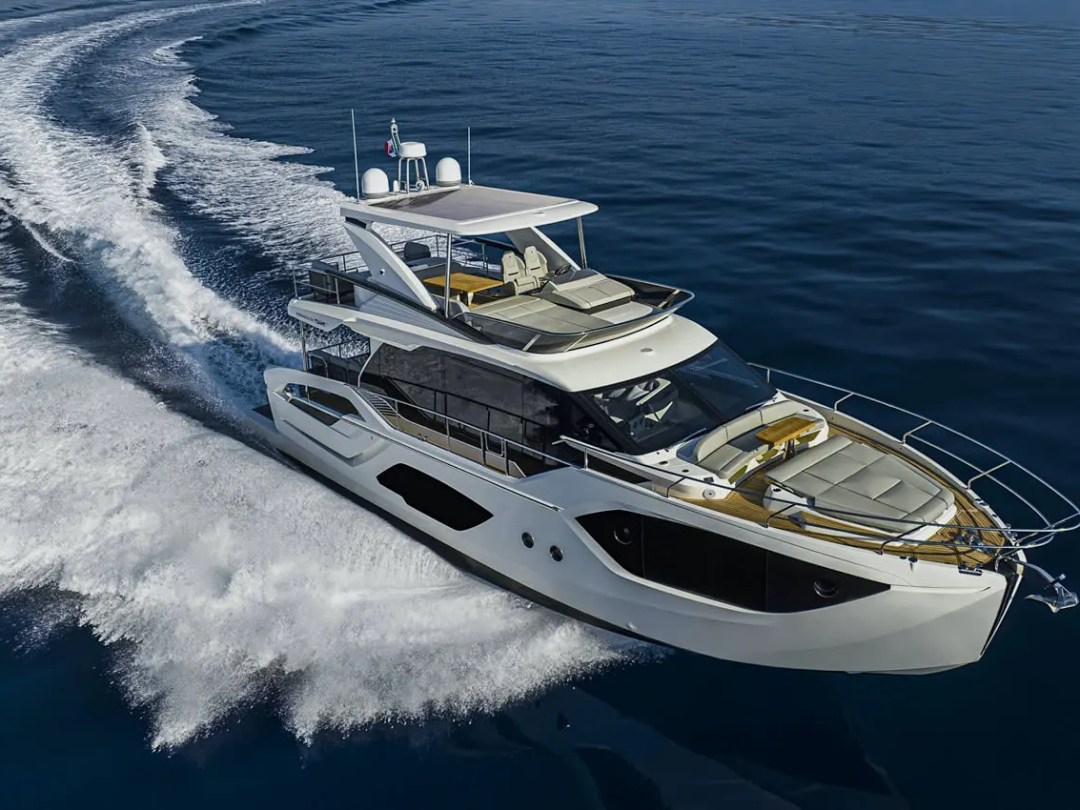 52' Absolute Yacht Charter aerial view cruising across open water featuring a flybridge, bow lounge seating, expansive decks, and luxury performance near Miami and Biscayne Bay