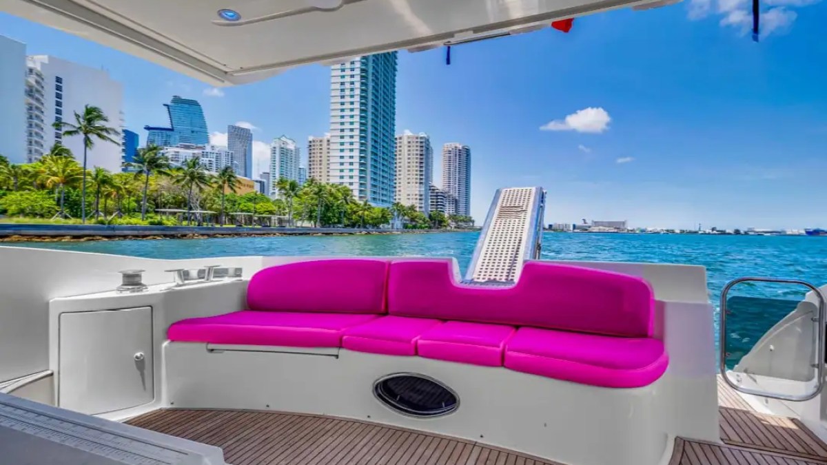 Aft dining table of 55′ Azimut yacht overlooking water