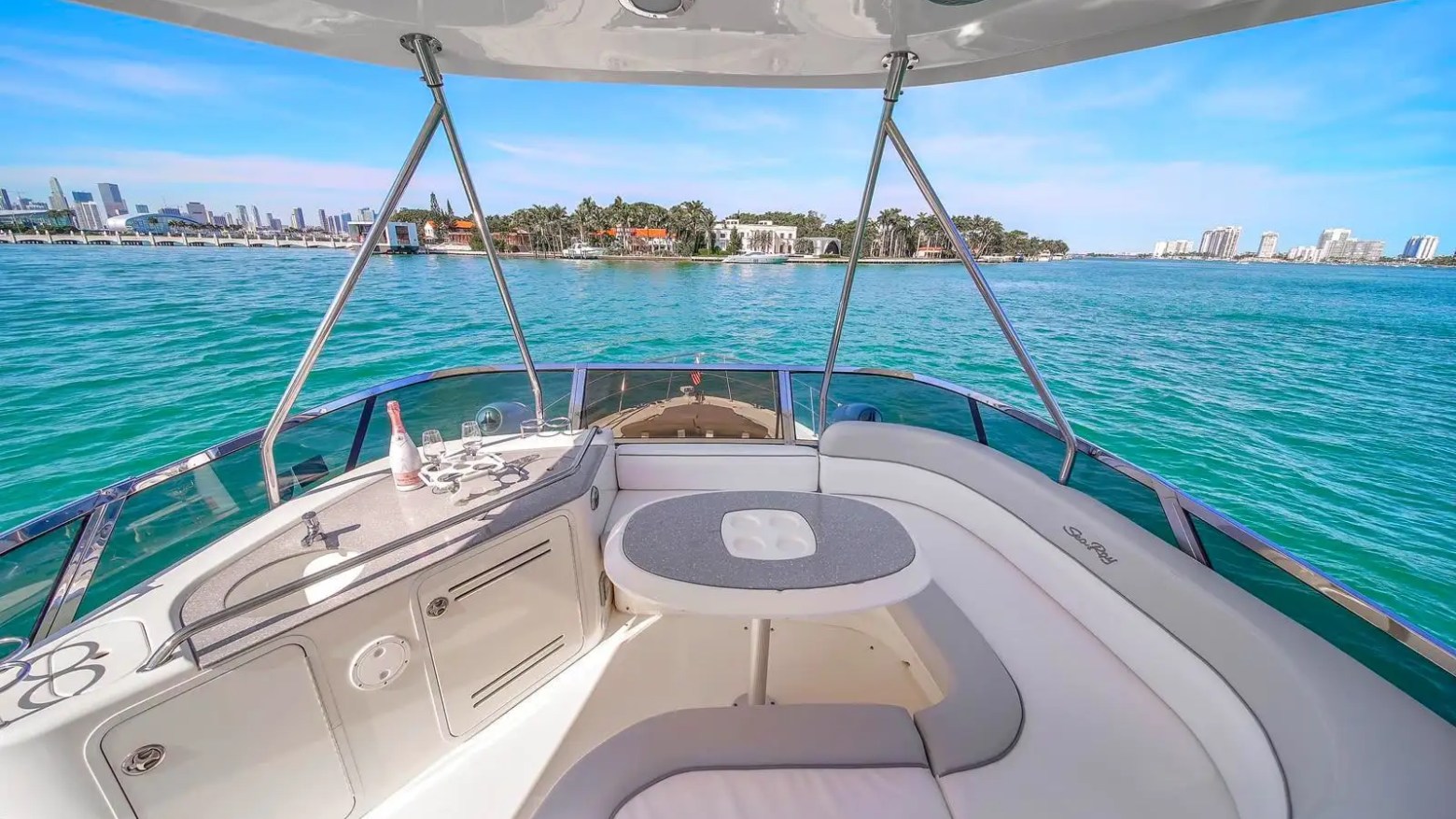 56′ SeaRay yacht flybridge table and seating overlooking Miami Beach waters