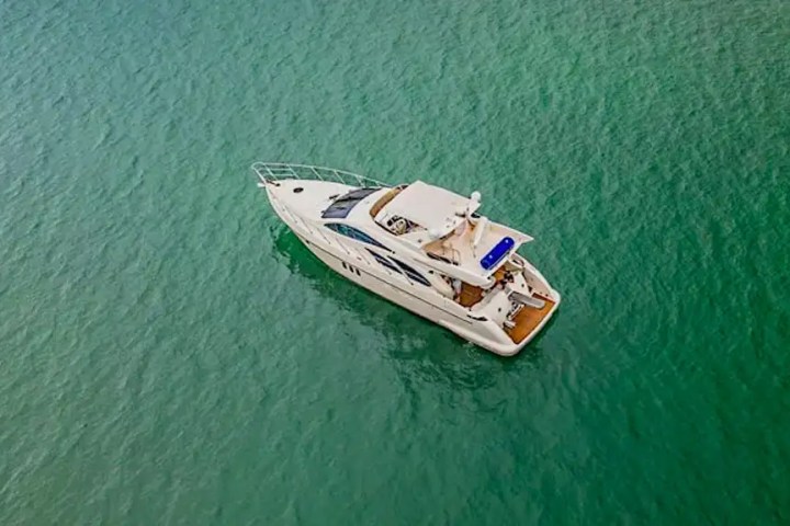 Guests relaxing on bow sunpads aboard Azimut 57