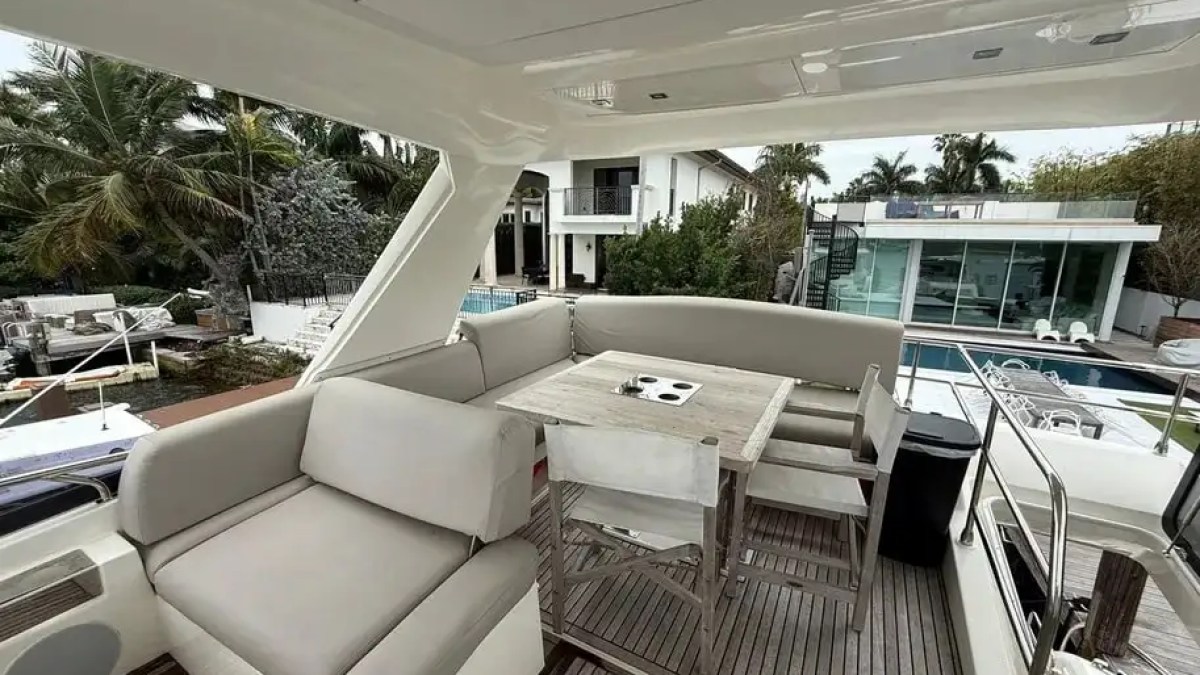 Aft flybridge seating on a 60′ Prestige yacht overlooking Miami Beach waters