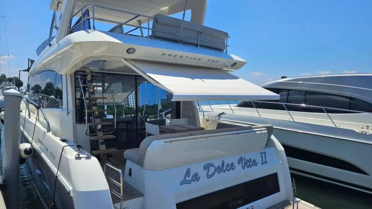 Luxury yacht 'La Dolce Vita II' docked with a canopy and visible upper deck.