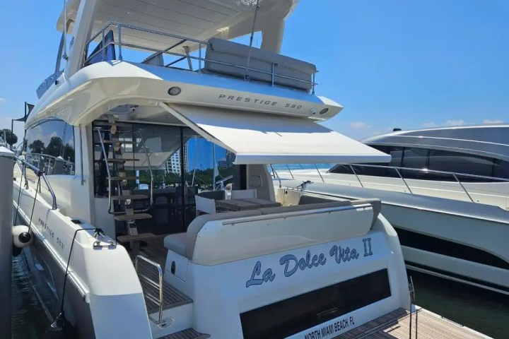 Luxury yacht 'La Dolce Vita II' docked with a canopy and visible upper deck.