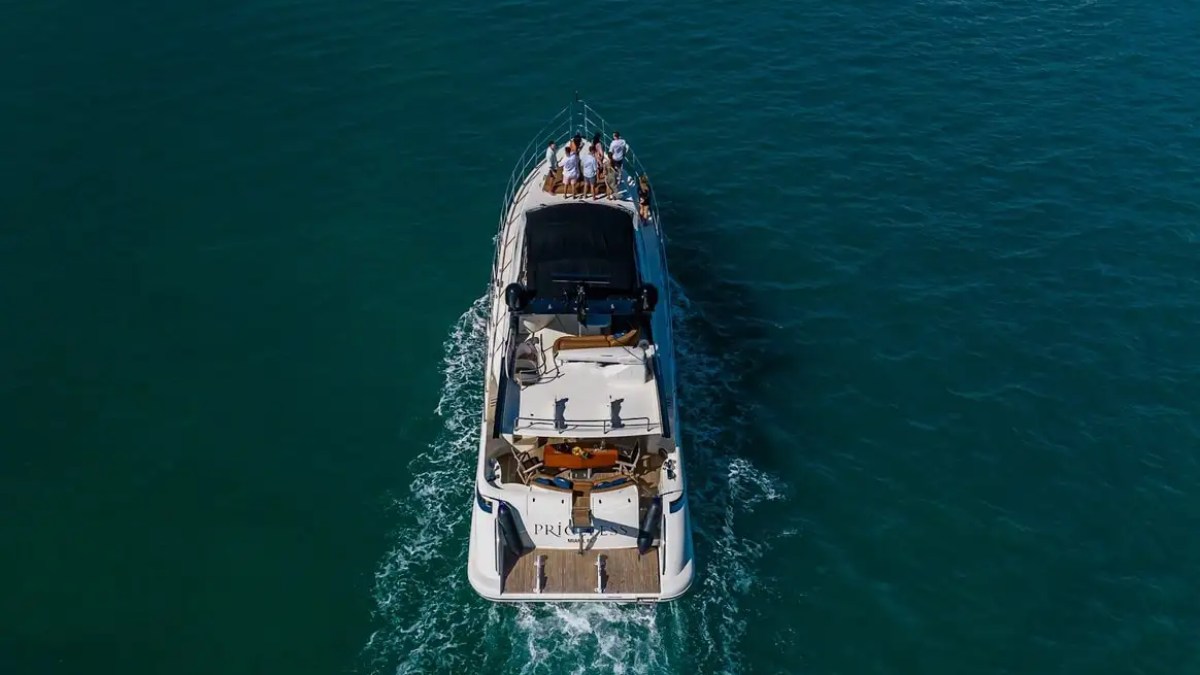 62′ Azimut 2 yacht cruising toward golden hour