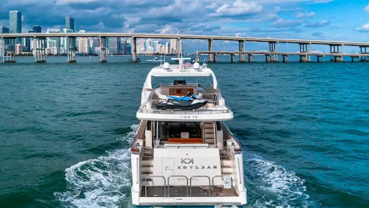 75' Aicon yacht charter cruising near Miami skyline and bridge in Biscayne Bay