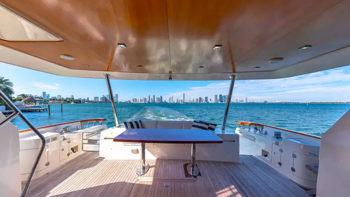 75' Aicon yacht charter aft deck lounge with Miami skyline view on Biscayne Bay