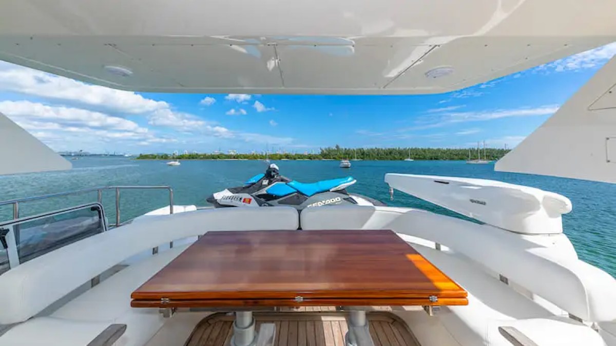 75' Aicon yacht charter flybridge seating with jet ski in Miami Beach on Biscayne Bay