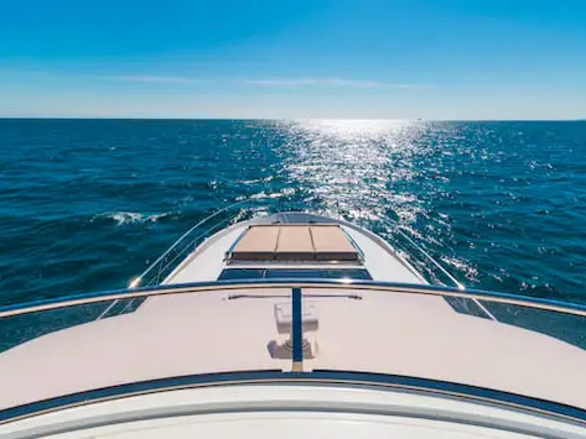 75′ Prestige yacht anchored near sandbar with guests relaxing