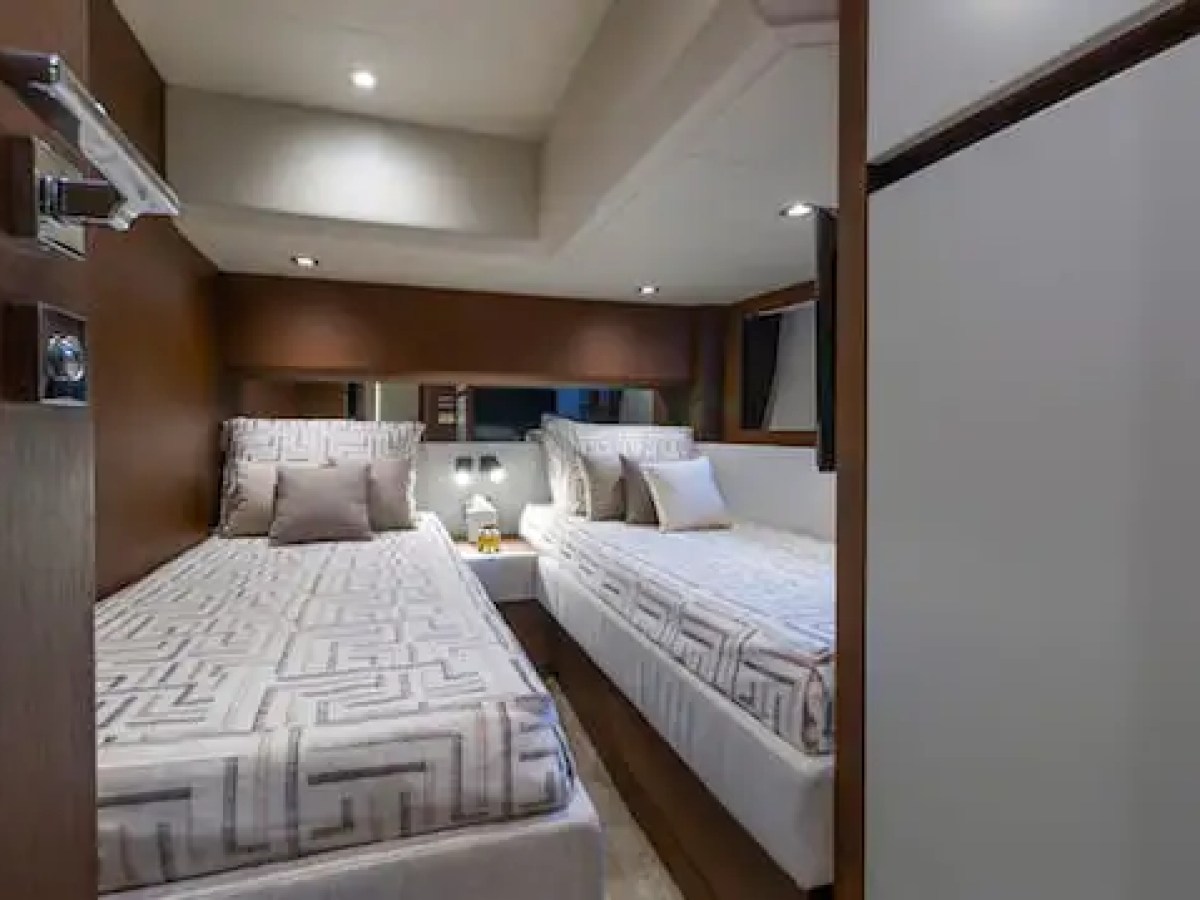 Interior view of a small room with two twin beds and modern decor.
