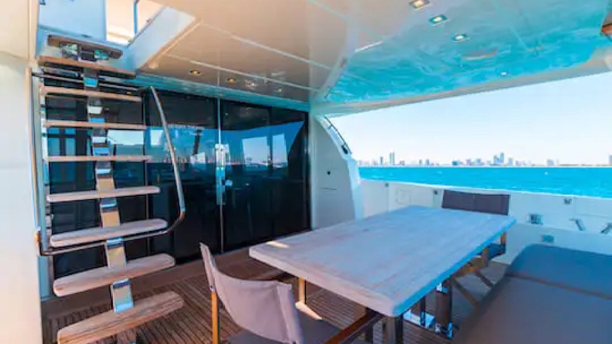 Aft deck dining table on 75′ Prestige yacht at Turnberry Marina