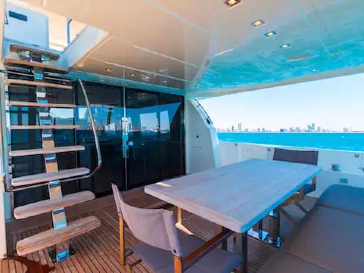 Aft deck dining table on 75′ Prestige yacht at Turnberry Marina