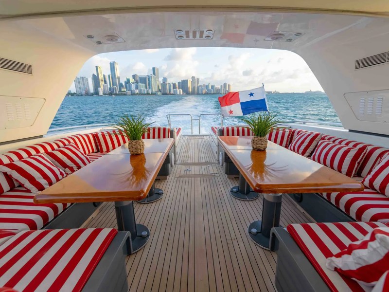 84' Mangusta yacht charter aft deck dining Miami Beach Biscayne Bay skyline