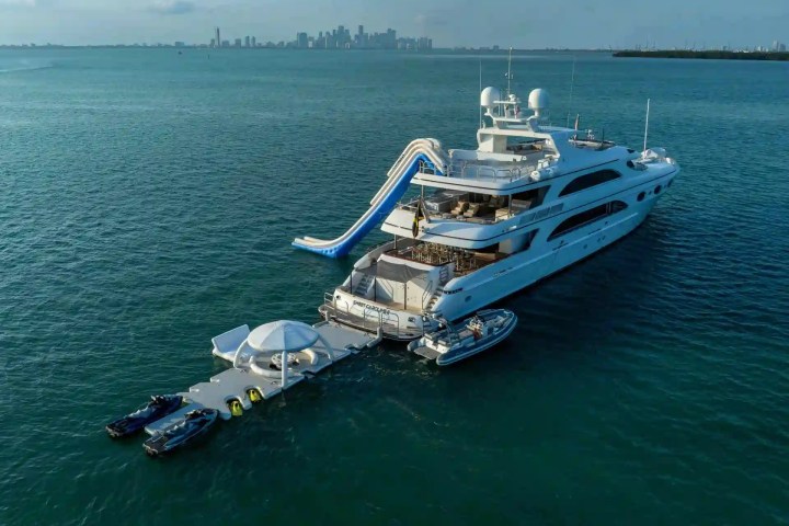 Luxury yacht with a slide and attached platform in open water