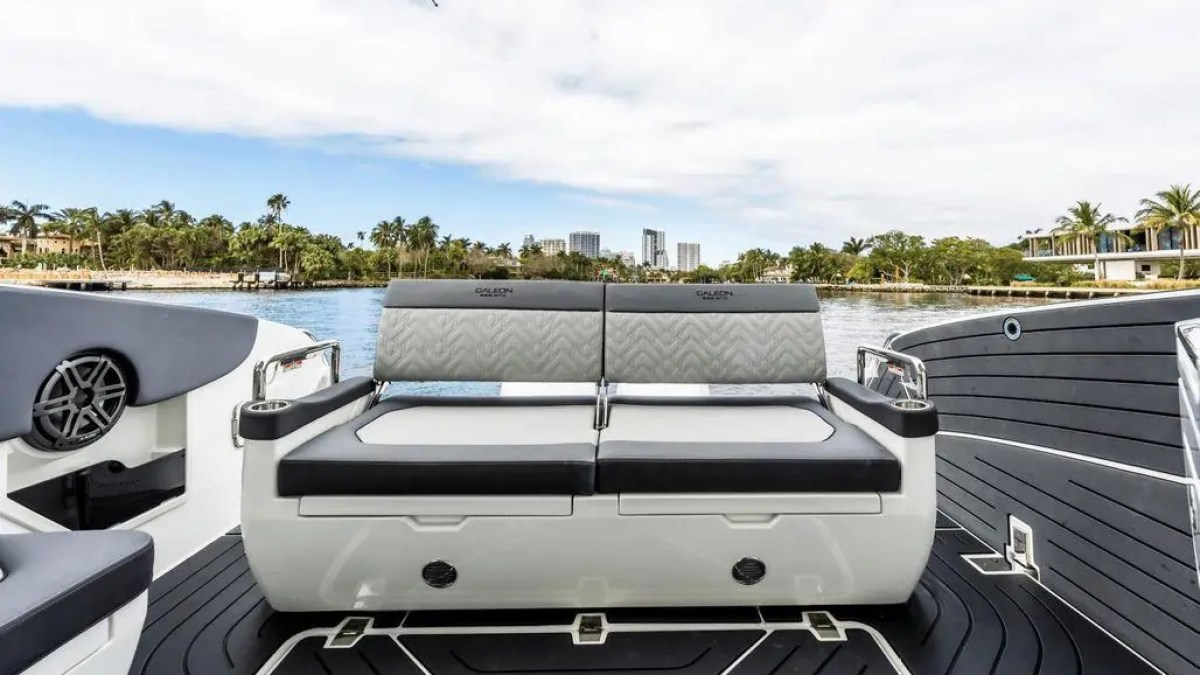 Luxury boat seating with a water view and distant city skyline.