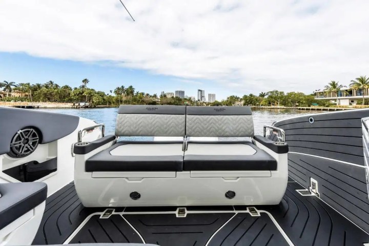 Luxury boat seating with a water view and distant city skyline.
