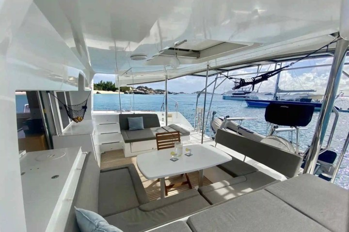 Interior of a luxury yacht with seating, table, and ocean view.