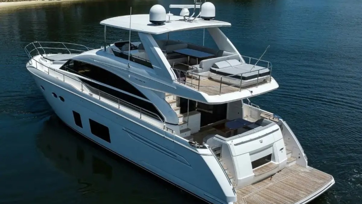 Large white yacht with multiple decks on a calm body of water.