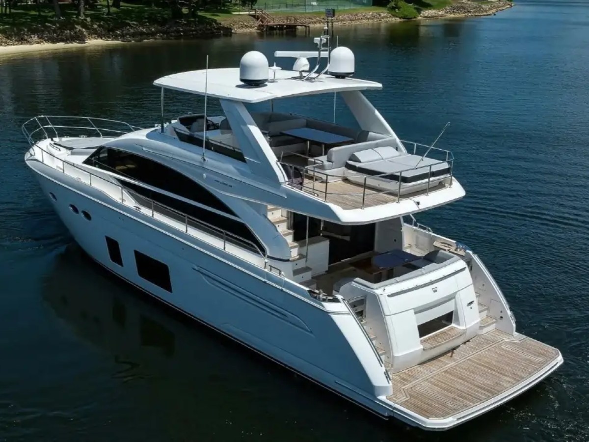 Large white yacht with multiple decks on a calm body of water.