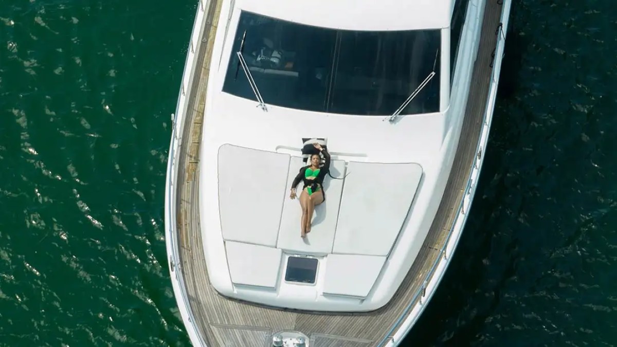 78' Ferretti yacht charter aerial view bow sunpad lounging in Miami Beach waters