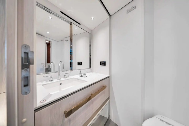 Modern bathroom with double sink, mirror, and minimalistic design.