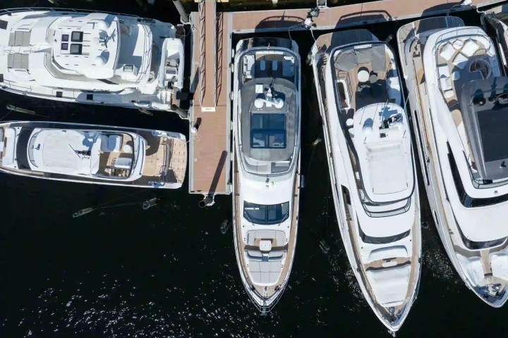 Top view of four yachts docked at a marina.