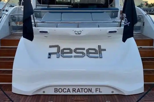Rear view of yacht named 'Reset', docked with BOCA RATON, FL on stern.