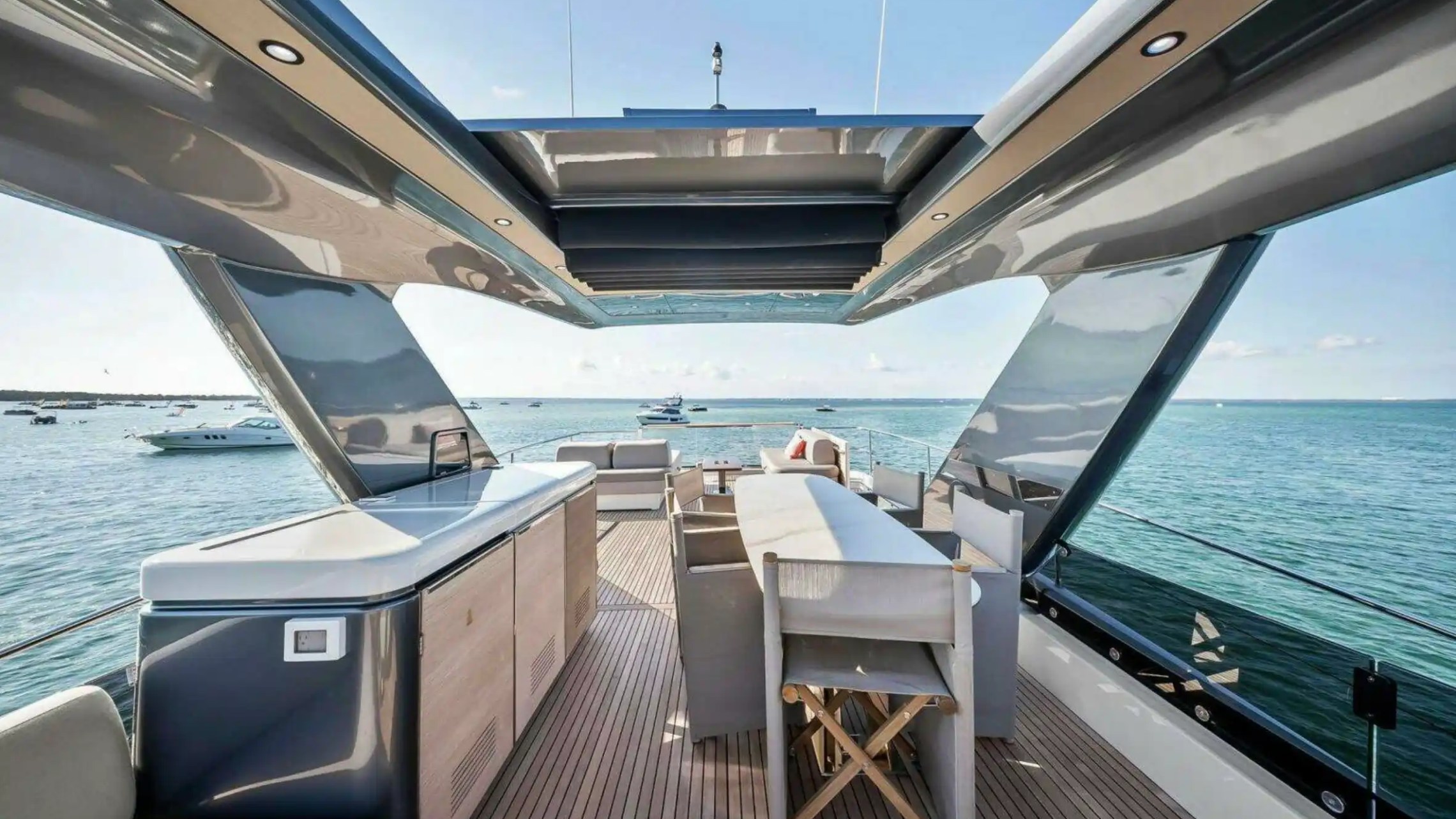 Luxury yacht deck with stylish seating and sea view under a sleek canopy.