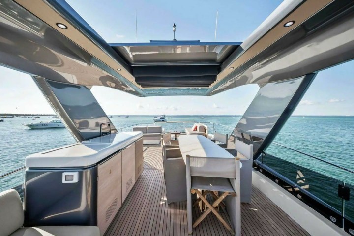 Luxury yacht deck with stylish seating and sea view under a sleek canopy.
