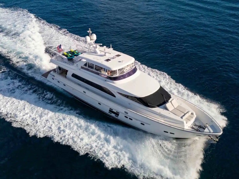 Offshore aerial view of a 91' Horizon Yacht Charter cruising at speed through deep blue Atlantic waters near Jupiter with a dramatic wake, flybridge, and expansive foredeck visible.