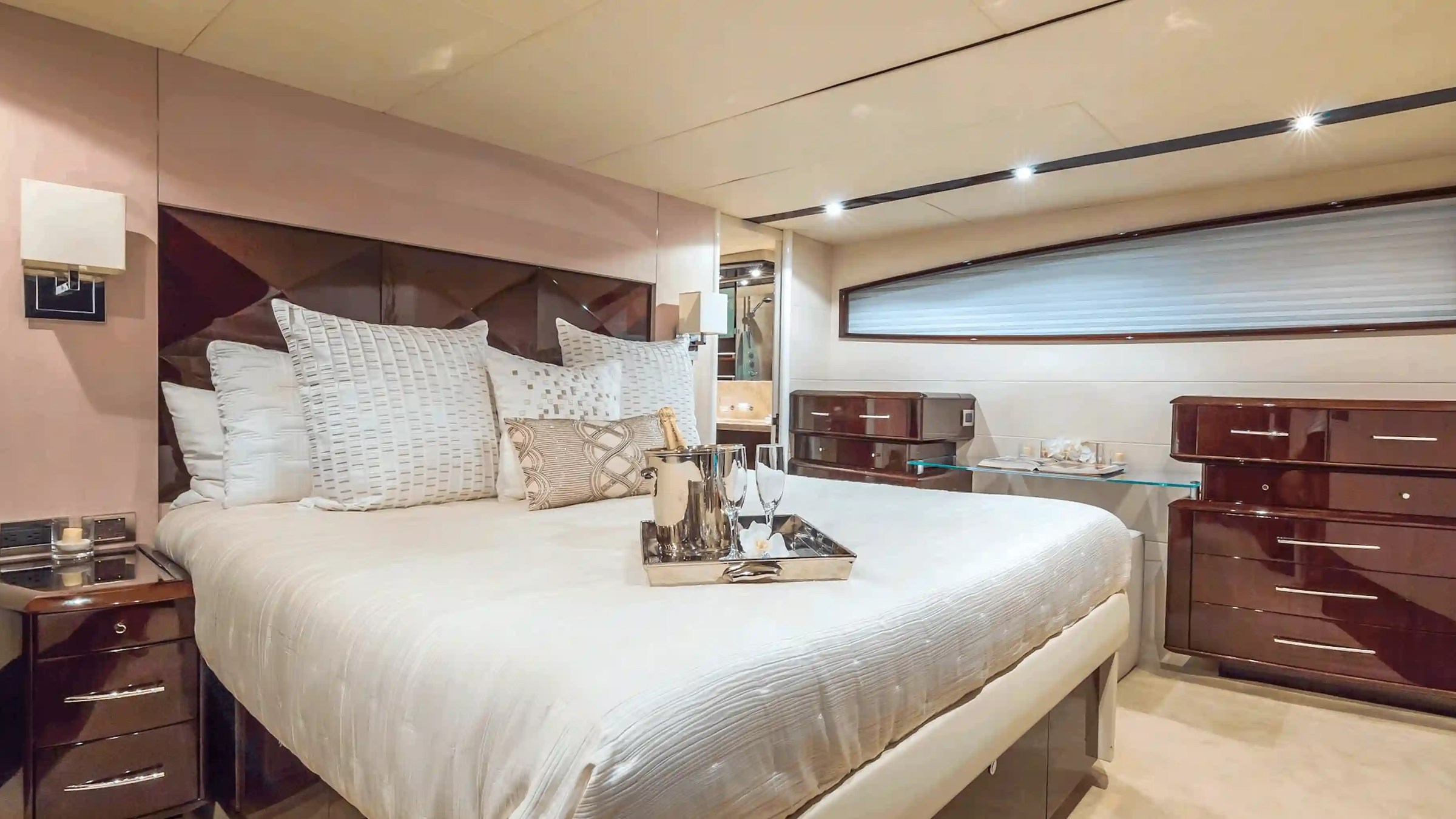 75' Lazzara yacht charter luxury stateroom interior with king bed in Miami Beach