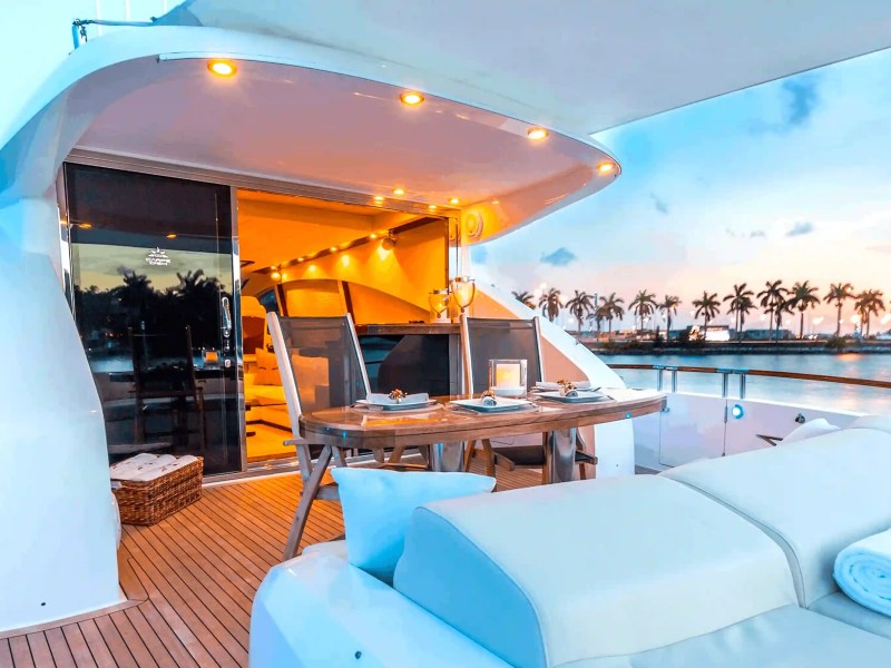 75' Lazzara yacht charter aft deck dining at sunset Miami Beach Biscayne Bay