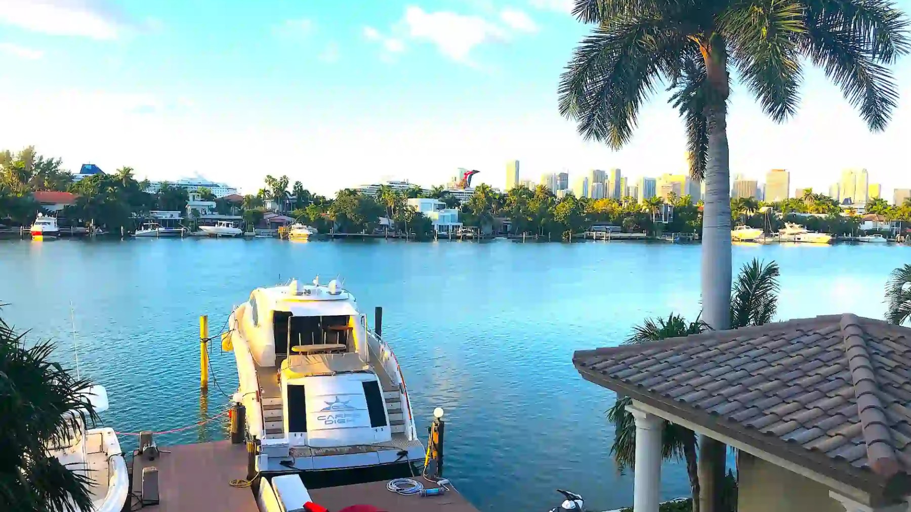 75' Lazzara yacht charter docked at Miami Beach waterfront mansion on Biscayne Bay