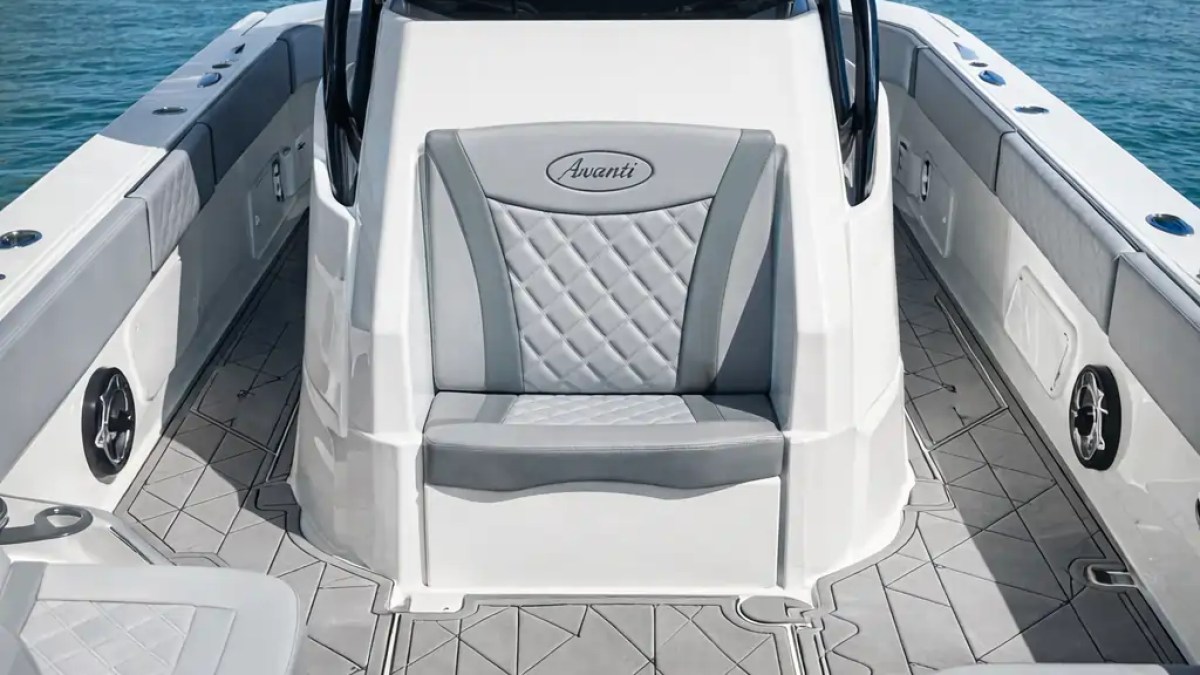 Interior of a boat with seating, labeled 'Avanti,' on calm blue water under a blue sky.