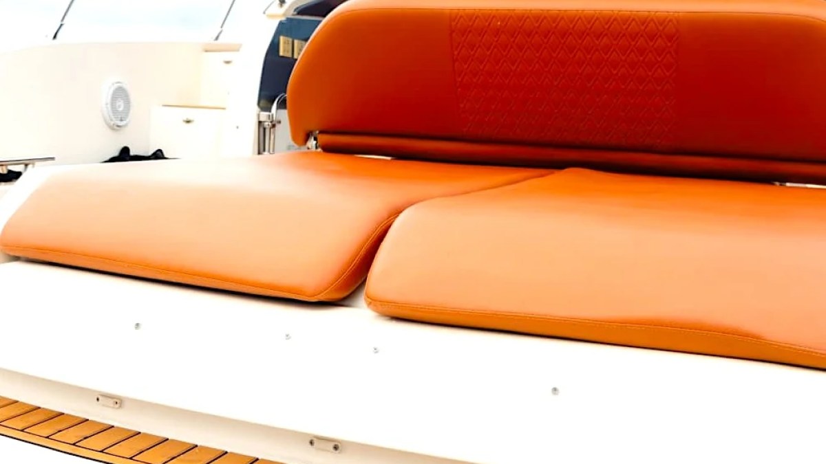 Orange seats on a boat with 'Carpe Diem' written on the side.