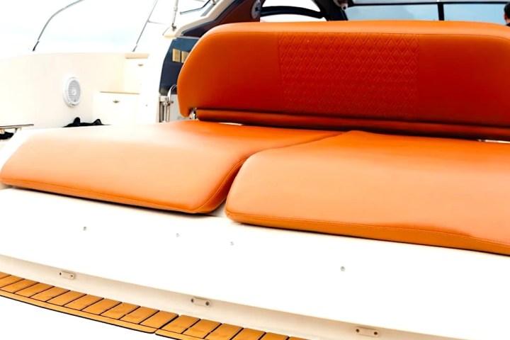 Orange seats on a boat with 'Carpe Diem' written on the side.