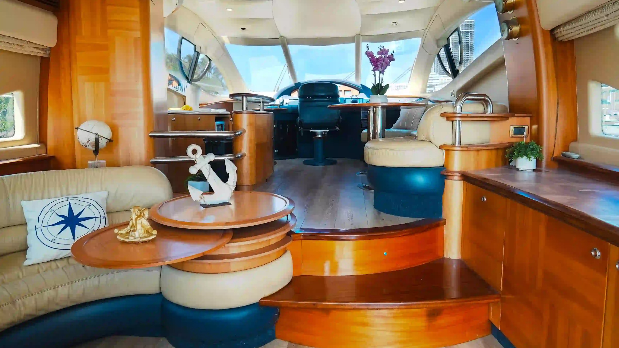 Luxurious yacht interior with leather seating, wooden decor, and nautical ornaments.